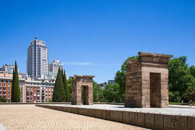 The stone gateways of the Temple of Debod, with Madrid buildings behind