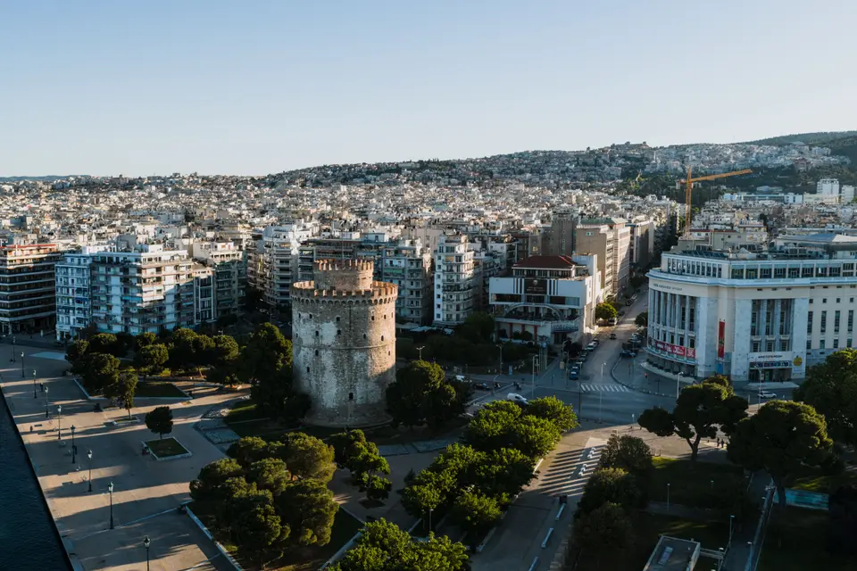 Aerial view of the Thessaloniki waterfront with the White Tower among the trees and the city behind